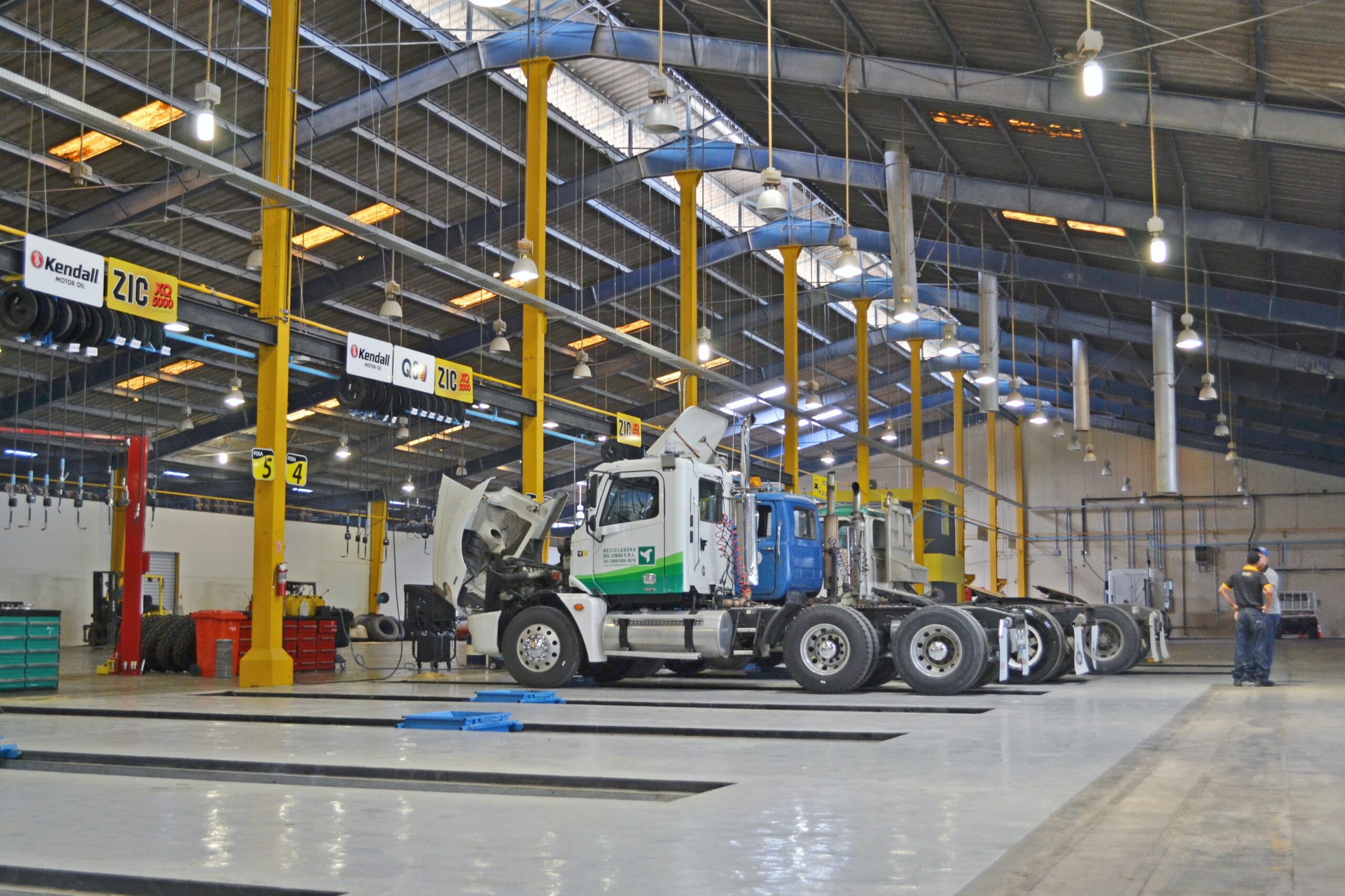 Industrial vehicle maintenance facility representing operational environments and integrated infrastructure